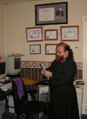 Fr. Geof working in the Office, filling paperwork from a wedding.