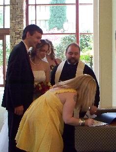 A wedding party signing the couple's Certificate.